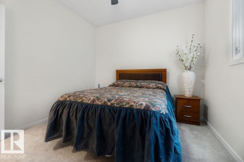 Bedroom with light-toned walls, gray carpet flooring, and a ceiling fan - 3623 6 Street, Edmonton, AB - Indoor Photo Showing Bedroom