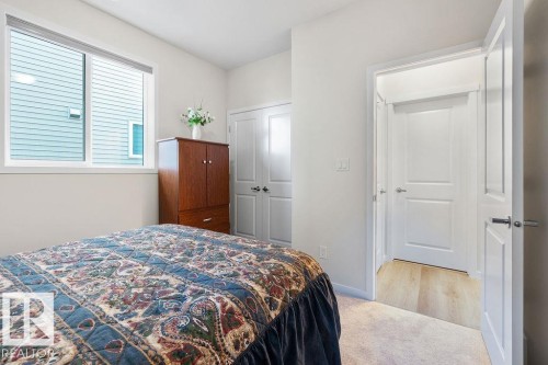 Bedroom featuring a sliding window, white trim, and light wall finishes - 3623 6 Street, Edmonton, AB - Indoor Photo Showing Bedroom