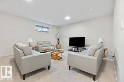 Spacious recreation room featuring recessed lighting, a neutral color palette, plush carpet flooring, a high window, and ample wall space - 3623 6 Street, Edmonton, AB - Indoor