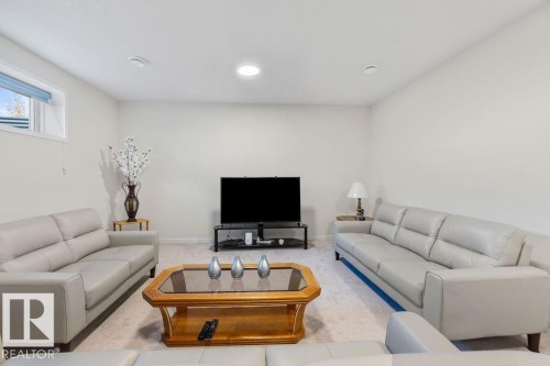 Recessed lighting illuminating a spacious room with light-toned walls and plush carpeting - 3623 6 Street, Edmonton, AB - Indoor Photo Showing Living Room