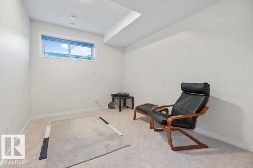 Carpeted room with neutral wall tones and a single horizontal window - 3623 6 Street, Edmonton, AB - Indoor Photo Showing Other Room