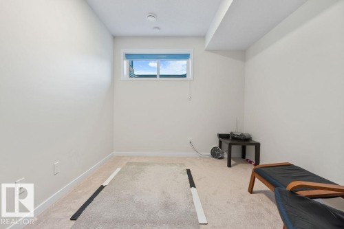 Carpeted room with a rectangular window - 3623 6 Street, Edmonton, AB - Indoor Photo Showing Other Room