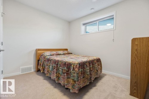Carpeted room featuring a horizontal window and light-toned walls - 3623 6 Street, Edmonton, AB - Indoor Photo Showing Bedroom