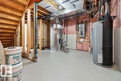 Unfinished basement space with exposed framing and a painted concrete floor - 3623 6 Street, Edmonton, AB - Indoor Photo Showing Basement