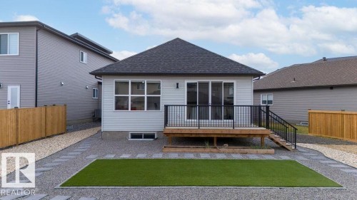 Rear exterior featuring light grey siding and a dark shingle roof - 3623 6 Street, Edmonton, AB - Outdoor With Exterior