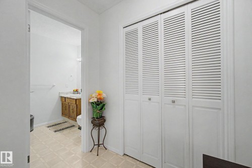 Louvered bi-fold closet doors featuring square silver hardware - 17305 60 Ave, Edmonton, AB 
