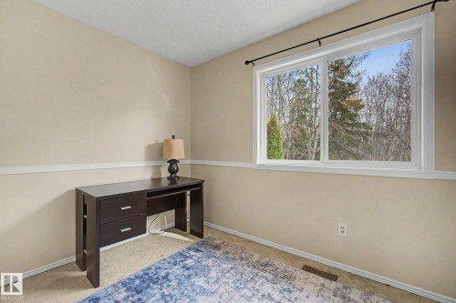 Bright room featuring a large window with white trim, offering a natural outdoor backdrop - 17305 60 Ave, Edmonton, AB 