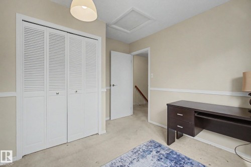 White louvered bi-fold closet doors, neutral wall paint, and white trim - 17305 60 Ave, Edmonton, AB 