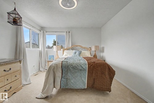 Bedroom featuring carpet flooring, white walls, and a ceiling-mounted light fixture - 17305 60 Ave, Edmonton, AB 