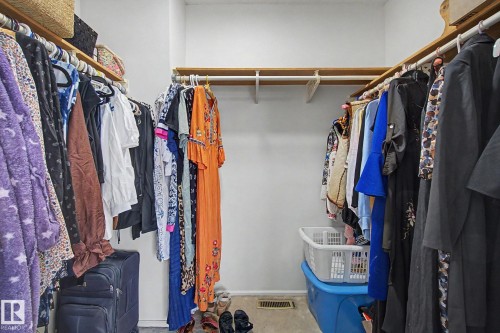 Walk-in closet featuring multiple clothing rods and upper shelving - 17305 60 Ave, Edmonton, AB 