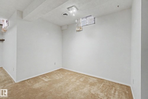Light beige carpeting with white baseboards and painted walls - 17305 60 Ave, Edmonton, AB 