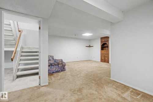 Spacious room with light beige carpet flooring and white painted walls - 17305 60 Ave, Edmonton, AB 