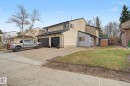 Two-story residence featuring a stucco exterior with light-toned siding - 17305 60 Ave, Edmonton, AB 