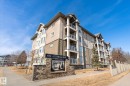The property is a multi-story building featuring balconies with glass railings - 104 612 111 Street Sw, Edmonton, AB  - Outdoor With Facade 