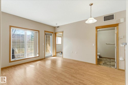 The property features light wood flooring and neutral-colored walls throughout - 104 612 111 Street Sw, Edmonton, AB - Indoor Photo Showing Other Room