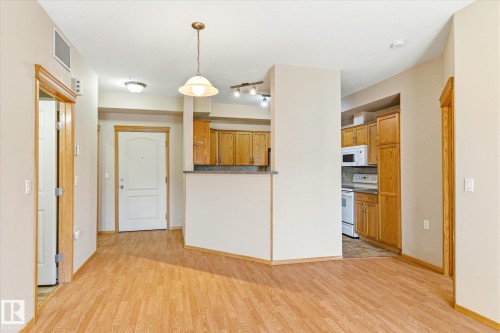 The property features light wood flooring throughout the main living areas - 104 612 111 Street Sw, Edmonton, AB - Indoor