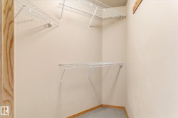 This closet features built-in wire shelving and a neutral color palette - 