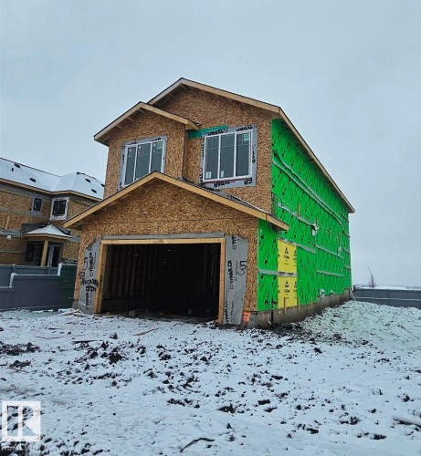 Two-story residential structure under construction featuring a prominent front-facing garage - 53 Mockingbird Cres, Fort Saskatchewan, AB - Outdoor