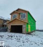 Two-story residential structure under construction featuring a prominent front-facing garage - 53 Mockingbird Cres, Fort Saskatchewan, AB  - Outdoor 