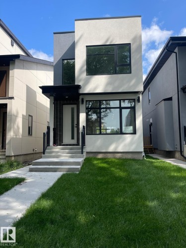 Contemporary two-story residence featuring a striking light stucco facade with dark accents - 10227 146 Street, Edmonton, AB - Outdoor
