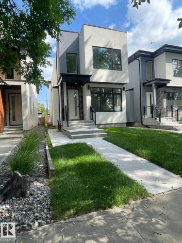 Modern two-story facade featuring contrasting light and dark stucco finishes - 10227 146 Street, Edmonton, AB - Outdoor