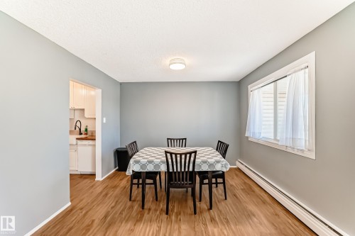 Dining area with wood-finish flooring, light gray walls, and a white ceiling - 423 5125 Riverbend Road, Edmonton, AB - Indoor Photo Showing Dining Room