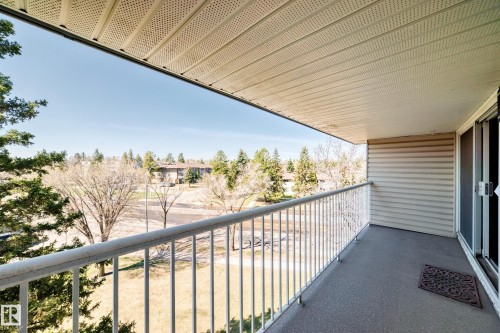 Private balcony with a metal railing, concrete flooring, and a sliding glass door - 423 5125 Riverbend Road, Edmonton, AB - Outdoor With Balcony With Exterior
