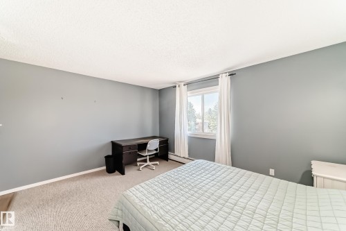 Carpeted room with light gray walls and white trim - 423 5125 Riverbend Road, Edmonton, AB - Indoor Photo Showing Bedroom