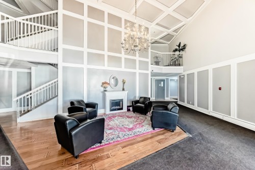 Two-story foyer featuring soaring ceilings with a coffered design and an elegant chandelier - 423 5125 Riverbend Road, Edmonton, AB - Indoor