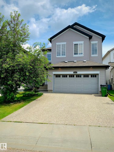 Two-story residence featuring light gray siding and a dark roofline - 1015 61 Street, Edmonton, AB 