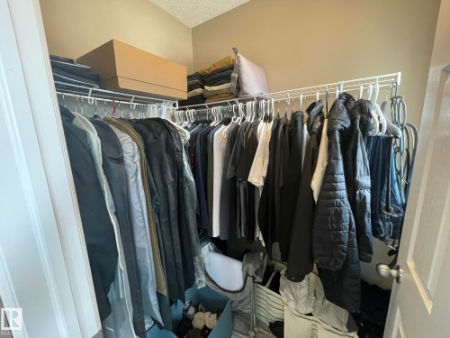 Closet featuring wire shelving system, multiple hanging rods, and light beige wall paint - 871 Ebbers Crescent, Edmonton, AB - Indoor With Storage