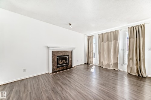 115 Keystone Lane, Leduc, AB - Indoor Photo Showing Living Room With Fireplace