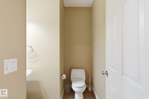 Powder room featuring a white pedestal sink, chrome towel ring, and a white toilet - 30 Valleyview Ridge, Fort Saskatchewan, AB - Indoor Photo Showing Bathroom