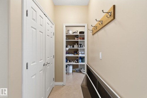Interior hallway with two white bifold closet doors - 30 Valleyview Ridge, Fort Saskatchewan, AB - Indoor Photo Showing Other Room