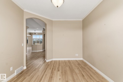Hardwood flooring extends throughout this room, featuring light beige walls and white trim - 30 Valleyview Ridge, Fort Saskatchewan, AB - Indoor Photo Showing Other Room