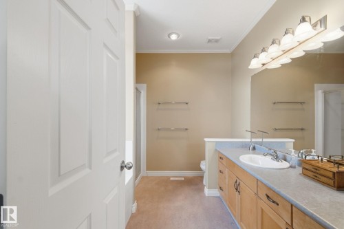 Bathroom featuring a light wood-finish vanity with a single sink and a broad countertop - 30 Valleyview Ridge, Fort Saskatchewan, AB - Indoor Photo Showing Bathroom