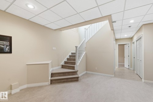 Carpeted stairs with white balusters and handrail - 30 Valleyview Ridge, Fort Saskatchewan, AB - Indoor Photo Showing Other Room