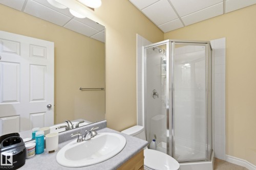 Bathroom featuring a single vanity with an oval sink, chrome faucet, and a large wall-mounted mirror - 30 Valleyview Ridge, Fort Saskatchewan, AB - Indoor Photo Showing Bathroom
