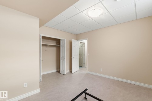 Neutral-toned room featuring light beige walls and light-colored carpeting - 30 Valleyview Ridge, Fort Saskatchewan, AB - Indoor Photo Showing Other Room