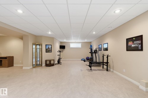 Expansive finished lower level featuring recessed lighting, a drop ceiling, neutral wall paint, and light-colored flooring - 30 Valleyview Ridge, Fort Saskatchewan, AB - Indoor Photo Showing Basement