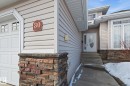 Entryway featuring light-toned horizontal siding and a multi-toned stone veneer foundation - 30 Valleyview Ridge, Fort Saskatchewan, AB  - Outdoor 