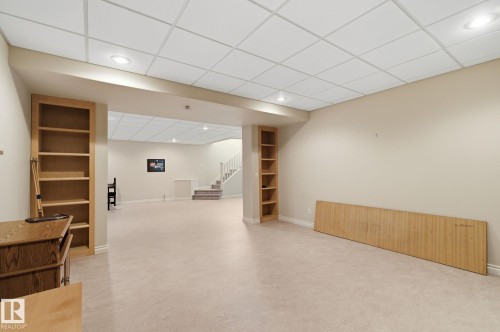 Spacious lower level featuring recessed lighting, light-toned carpeting, and built-in shelving units - 30 Valleyview Ridge, Fort Saskatchewan, AB - Indoor