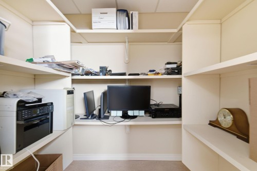 Built-in shelving with integrated desk space - 30 Valleyview Ridge, Fort Saskatchewan, AB - Indoor Photo Showing Office