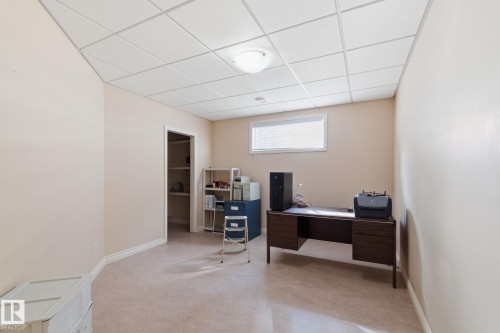 Versatile room featuring a drop ceiling with recessed lighting, neutral-toned walls, and a window with blinds - 30 Valleyview Ridge, Fort Saskatchewan, AB - Indoor