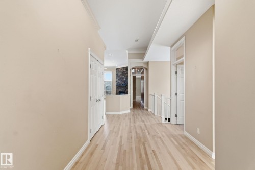 Hardwood flooring extends throughout this interior space, featuring neutral wall tones and white trim - 30 Valleyview Ridge, Fort Saskatchewan, AB - Indoor Photo Showing Other Room