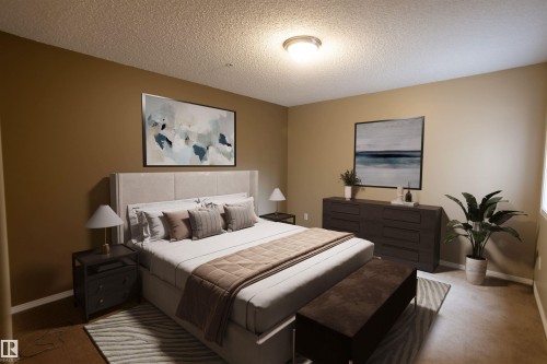 Neutral-toned bedroom featuring wall-to-wall carpeting and textured ceilings - 101 2420 108 Street, Edmonton, AB - Indoor Photo Showing Bedroom