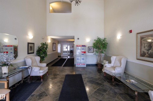 Spacious lobby featuring high ceilings and dark tile flooring - 101 2420 108 Street, Edmonton, AB - Indoor