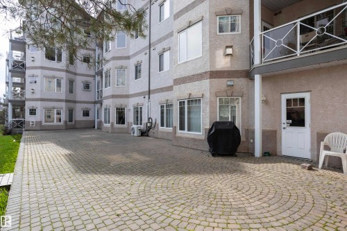 Expansive paver patio featuring a circular pattern - 101 2420 108 Street, Edmonton, AB - Outdoor