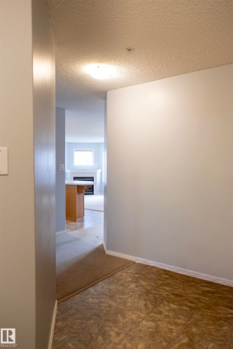 Foyer featuring patterned tile flooring and light-toned walls - 101 2420 108 Street, Edmonton, AB - Indoor Photo Showing Other Room