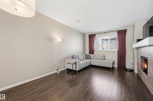 4 320 Secord Boulevard, Edmonton, AB - Indoor Photo Showing Living Room With Fireplace